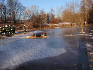 Korrekte Eisrettung der Feuerwehr. Mit Leiter zur Vergrößerung der Auflagefläche und gesichert mit einem Seil